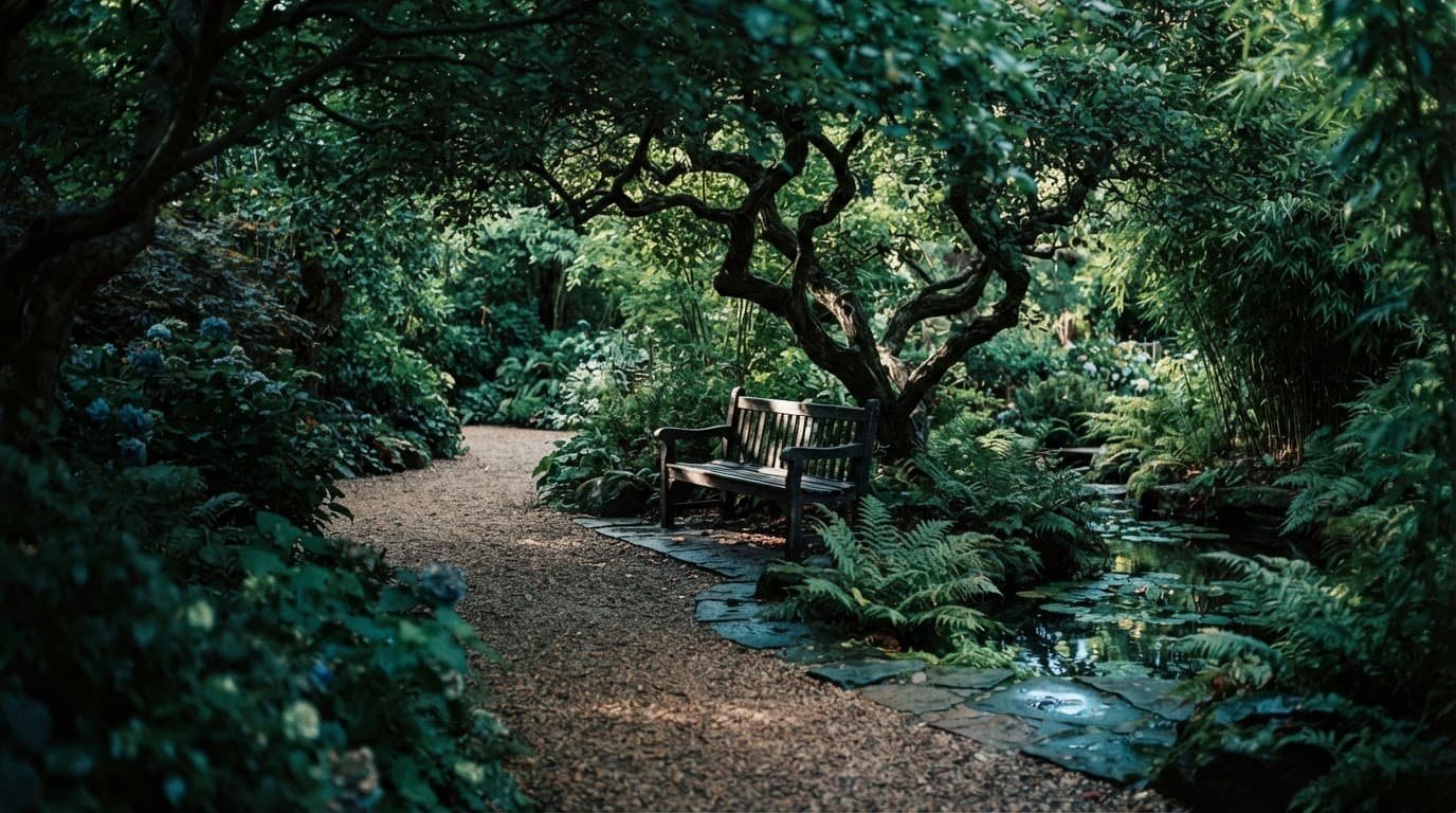 A shaded bench surrounded by lush greenery in a quiet theme park garden.